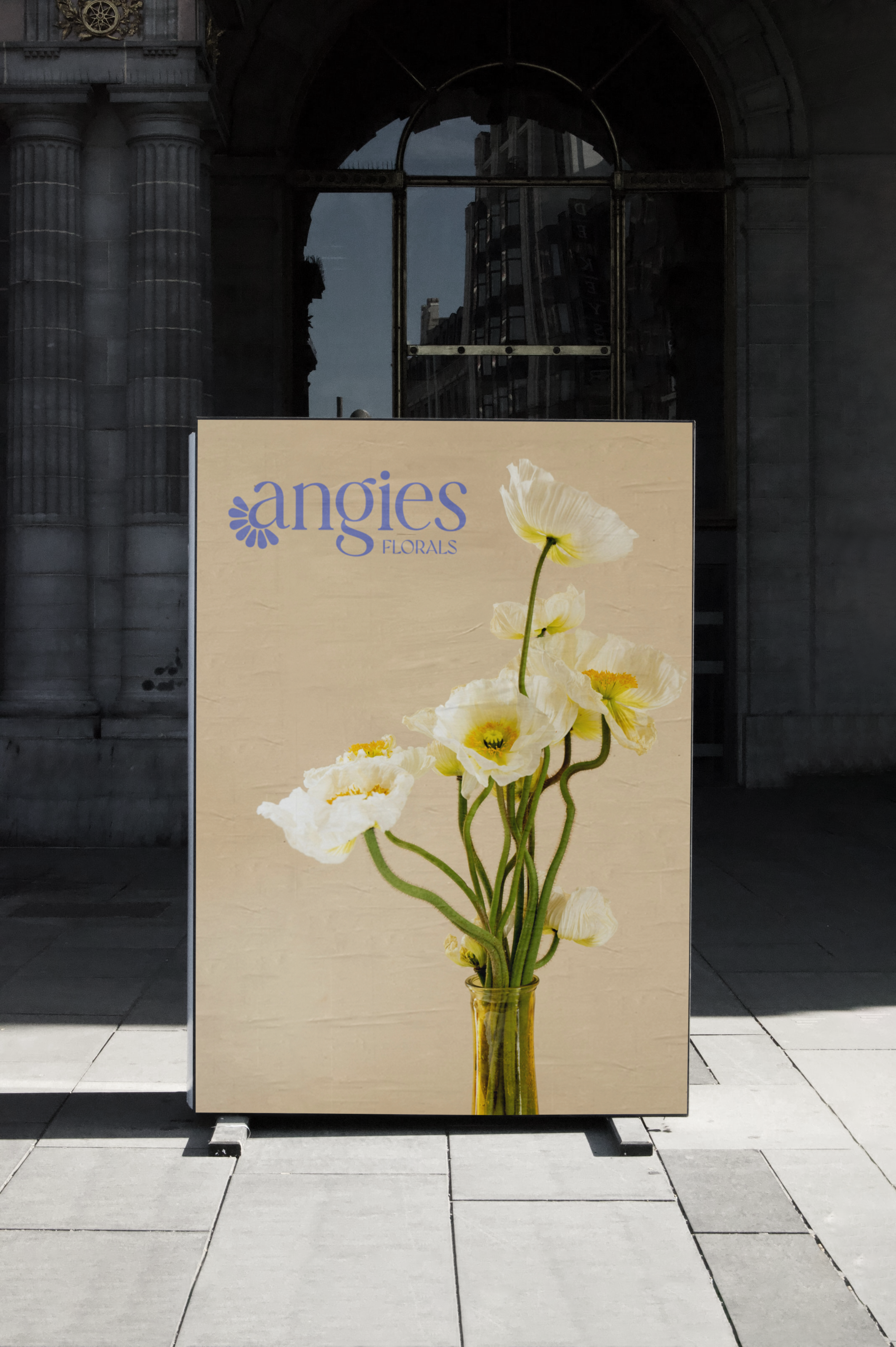 outdoor poster mockup with flowers and the Angies FLlrals logo in blue